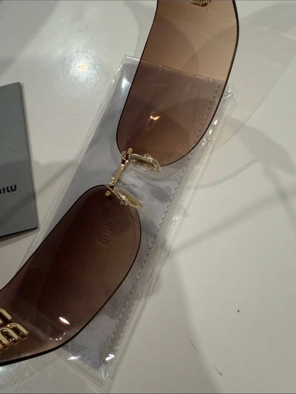 Miu Miu Brown Rimless Sunglasses with Gold Bridge